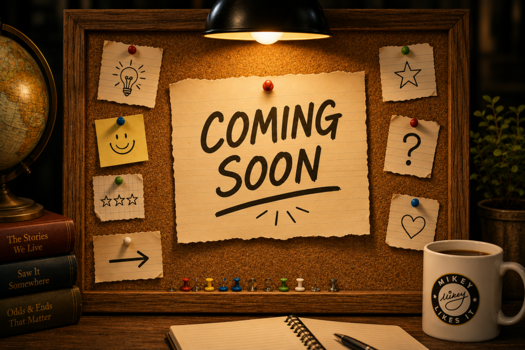 Bulletin board with a large "Coming Soon" note pinned above a Mikey Likes It coffee mug.