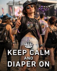 Young concertgoer wearing sunglasses and a festival wristband with the words “Keep Calm and Diaper On.”